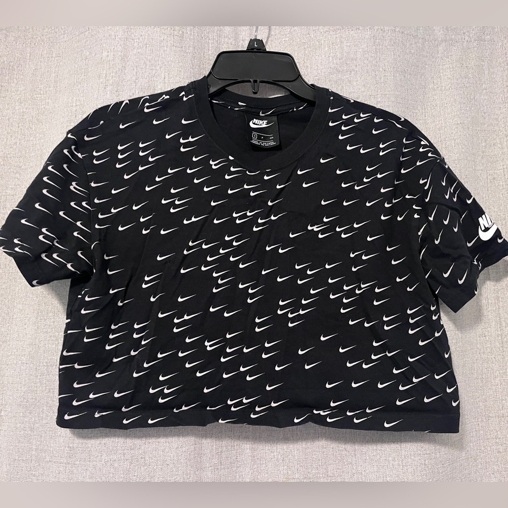Nike Women's Black Crop Top with White Swoosh Pattern. Size: Small